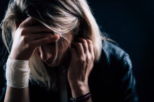 Depression – Depressed woman, covering face with hands