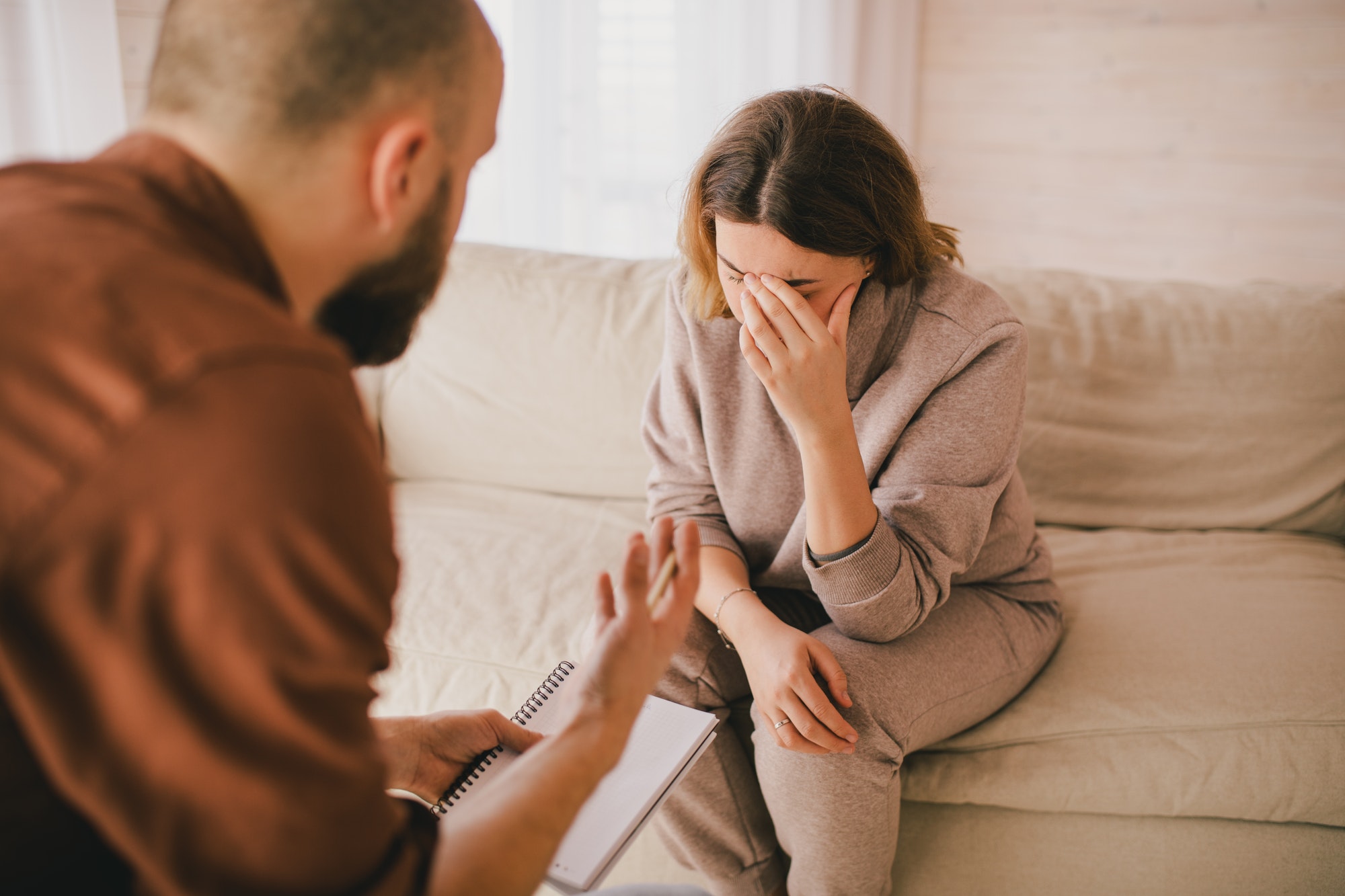 Psychiatrist consultinig depressive woman. Mental support session.